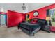 Bright main bedroom featuring a large bed and stylish decor with red walls at 2698 Sw 186Th Ct, Dunnellon, FL 34432