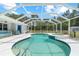 Screened-in pool area featuring a large pool, a jacuzzi and a patio at 2698 Sw 186Th Ct, Dunnellon, FL 34432