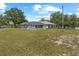 Backyard view of screened pool and patio area with ample green space in a rural setting at 2698 Sw 186Th Ct, Dunnellon, FL 34432