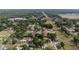 Aerial view of neighborhood featuring mature trees, grass lawns, and paved streets at 2819 Ne 32Nd Pl, Ocala, FL 34479