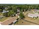 A residential area featuring a fenced backyard, mature trees, and a covered patio at 2819 Ne 32Nd Pl, Ocala, FL 34479