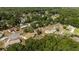 An aerial view shows the landscape and neighborhood homes surrounded by lush greenery at 2819 Ne 32Nd Pl, Ocala, FL 34479