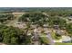 A quiet neighborhood featuring mature trees, residential homes, and paved roadways at 2819 Ne 32Nd Pl, Ocala, FL 34479