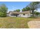 Spacious backyard featuring a well-maintained lawn and a cozy screened in porch for outdoor relaxation and entertaining at 2819 Ne 32Nd Pl, Ocala, FL 34479