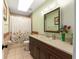 Bathroom featuring a shower-tub combo, vanity and a framed mirror at 2819 Ne 32Nd Pl, Ocala, FL 34479