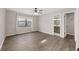 Spacious bedroom with hardwood floors, large window, and ensuite bathroom with modern finishes at 2819 Ne 32Nd Pl, Ocala, FL 34479