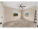 A bright bedroom is freshly painted with carpeting, and has a ceiling fan and large windows at 2819 Ne 32Nd Pl, Ocala, FL 34479