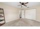 A bright bedroom has carpet, ceiling fan, closet and attached bathroom at 2819 Ne 32Nd Pl, Ocala, FL 34479
