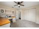 Neutral bedroom with a ceiling fan and natural light, built-in desk and large closet at 2819 Ne 32Nd Pl, Ocala, FL 34479