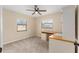 Neutral bedroom with a ceiling fan and natural light, and built-in desk with drawers at 2819 Ne 32Nd Pl, Ocala, FL 34479