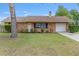 Charming brick home with a well-manicured lawn and attached one-car garage at 2819 Ne 32Nd Pl, Ocala, FL 34479