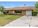 Charming brick home with a well-kept lawn and a long driveway for ample parking at 2819 Ne 32Nd Pl, Ocala, FL 34479
