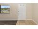 A view of a white front door with glass panes, and wood-look flooring at 2819 Ne 32Nd Pl, Ocala, FL 34479