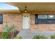 Close up on a charming brick house front door with black shutters and a well-kept lawn at 2819 Ne 32Nd Pl, Ocala, FL 34479