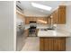 Bright kitchen with stainless steel appliances, wooden cabinetry, and a skylight providing ample natural light at 2819 Ne 32Nd Pl, Ocala, FL 34479