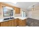 Well-lit kitchen with modern appliances, breakfast bar area, updated wooden cabinetry and a double basin sink at 2819 Ne 32Nd Pl, Ocala, FL 34479