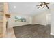 Bright and airy living room featuring new flooring, brick fireplace, and modern ceiling fan at 2819 Ne 32Nd Pl, Ocala, FL 34479