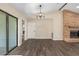 Living room featuring hardwood floors, brick fireplace, modern light fixture, and sliding glass door to outdoors at 2819 Ne 32Nd Pl, Ocala, FL 34479