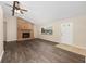 Inviting living room with wood-look flooring, a brick fireplace, and plenty of natural light at 2819 Ne 32Nd Pl, Ocala, FL 34479