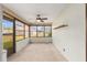Enclosed sunroom with ceiling fan and screened windows for airflow at 2819 Ne 32Nd Pl, Ocala, FL 34479