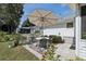 Charming backyard patio with ample seating and a shade umbrella, perfect for outdoor entertaining at 36 Gordon Ct, Leesburg, FL 34788