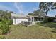 Spacious backyard with patio, sunroom, and lush landscaping, ideal for outdoor enjoyment at 36 Gordon Ct, Leesburg, FL 34788