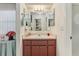 Bathroom with a vanity, mirrored cabinet, and ample storage space at 36 Gordon Ct, Leesburg, FL 34788