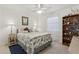 Bedroom featuring a decorative display shelf, a ceiling fan and neutral color scheme at 36 Gordon Ct, Leesburg, FL 34788
