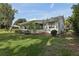 Well-maintained home exterior featuring a screened porch and landscaped yard, exuding charm at 36 Gordon Ct, Leesburg, FL 34788