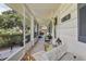 Charming screened in front porch with comfortable seating at 36 Gordon Ct, Leesburg, FL 34788