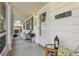 Inviting front porch with cozy seating and ample natural light at 36 Gordon Ct, Leesburg, FL 34788