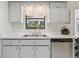 Kitchen featuring white cabinets, stainless steel appliances, and a sink with a window at 36 Gordon Ct, Leesburg, FL 34788