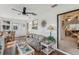 Cozy sunroom with a decorative sun accent, floral sofa, and view to another room at 36 Gordon Ct, Leesburg, FL 34788