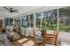 Bright sunroom with large windows, a ceiling fan, and a dining area overlooking the outdoor scenery at 36 Gordon Ct, Leesburg, FL 34788