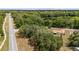 An aerial perspective of a home with a red tile roof, nestled amidst tall, mature trees and a serene street at 361 Oak Lane Drive Dr, Ocala, FL 34472