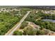 An aerial view of a home nestled between the road and a natural lake for a serene, scenic view at 361 Oak Lane Drive Dr, Ocala, FL 34472