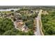 A scenic aerial view of the property showcasing the surrounding neighborhood and a glimpse of the nearby lake at 361 Oak Lane Drive Dr, Ocala, FL 34472