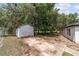 Backyard featuring a detached shed/garage and lush, mature trees at 361 Oak Lane Drive Dr, Ocala, FL 34472