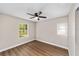 A cozy bedroom with wood-look floors, two windows, and natural light at 361 Oak Lane Drive Dr, Ocala, FL 34472