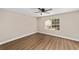 Bedroom with wood-look floors, base molding, neutral walls, ceiling fan, and bright window at 361 Oak Lane Drive Dr, Ocala, FL 34472