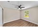 A cozy bedroom with wood-look floors, window, and ceiling fan at 361 Oak Lane Drive Dr, Ocala, FL 34472