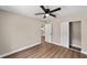A bright bedroom with wood-look floors, closet, and ceiling fan at 361 Oak Lane Drive Dr, Ocala, FL 34472