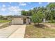 Charming single-story home featuring a well-manicured lawn and attached one car garage at 361 Oak Lane Drive Dr, Ocala, FL 34472