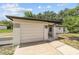 Single-story home featuring a well-manicured lawn and attached one car garage at 361 Oak Lane Drive Dr, Ocala, FL 34472