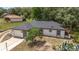 This home offers a clean, light exterior, completed with a single-car garage, tree, and well-kept lawn at 361 Oak Lane Drive Dr, Ocala, FL 34472