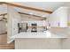 Bright kitchen with white cabinets, modern appliances, a large island, and a beamed ceiling at 361 Oak Lane Drive Dr, Ocala, FL 34472
