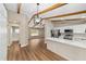 Kitchen view showcases wood-look floors, beamed ceiling, white cabinets, and stainless steel appliances at 361 Oak Lane Drive Dr, Ocala, FL 34472