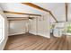 View of open living area with wood-look floors, beamed ceilings, and kitchen with white cabinets and island at 361 Oak Lane Drive Dr, Ocala, FL 34472