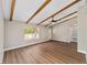 Inviting living room boasting wood-look flooring, a beamed ceiling with fan, and a bright window for natural light at 361 Oak Lane Drive Dr, Ocala, FL 34472