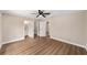 Spacious main bedroom featuring wood-look floors, ceiling fan, and ensuite bathroom at 361 Oak Lane Drive Dr, Ocala, FL 34472